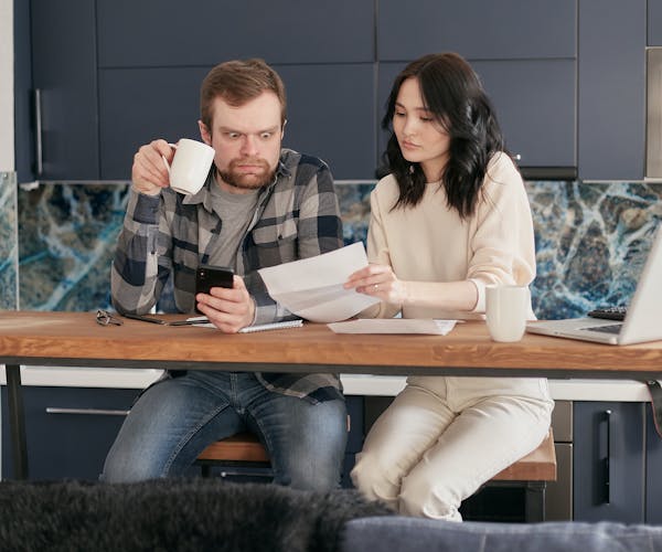 A photo of a couple who are purchasing their next home and being surprised with additional costs that come with the process