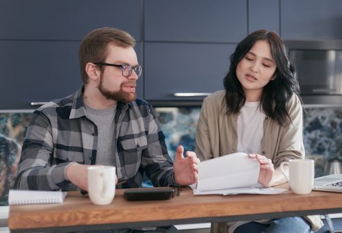 Free Two colleagues having a discussion during a casual team meeting with coffee and documents. Stock Photo