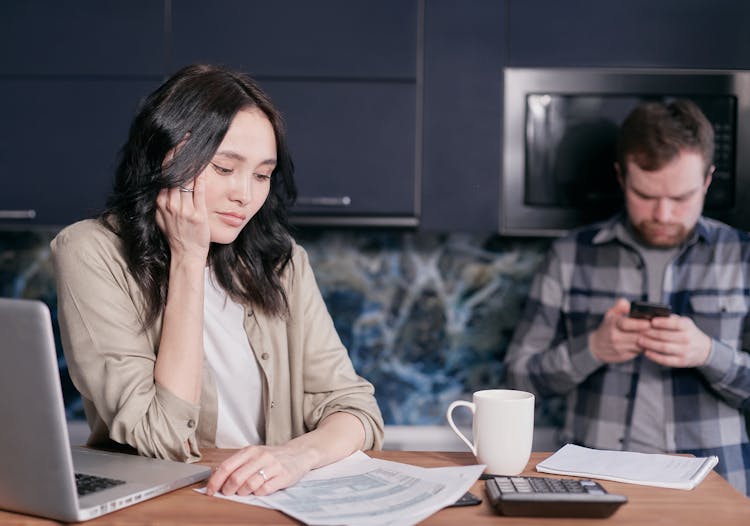 Stressed Woman Looking At Documents