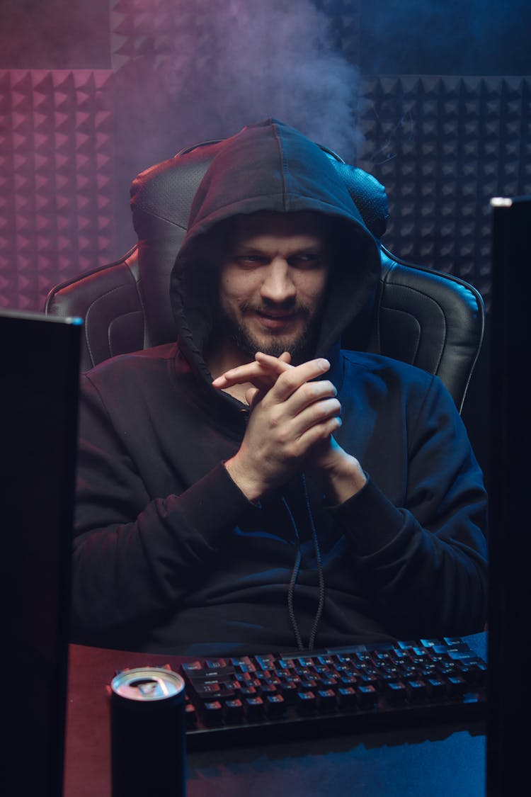 Man In Black Hoodie Sitting On Leather Chair