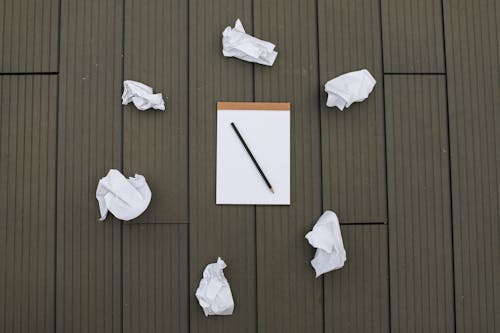 Photograph of Crumpled Paper Near a Pencil