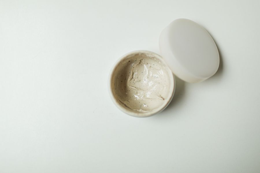 Open jar of rich moisturizing cream