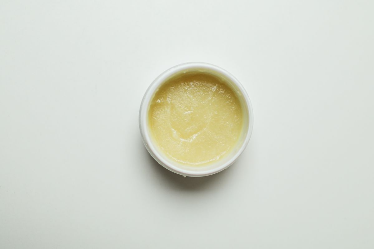 Open jar of nourishing body butter