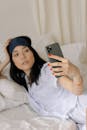 Woman in White Pajama Taking Selfie