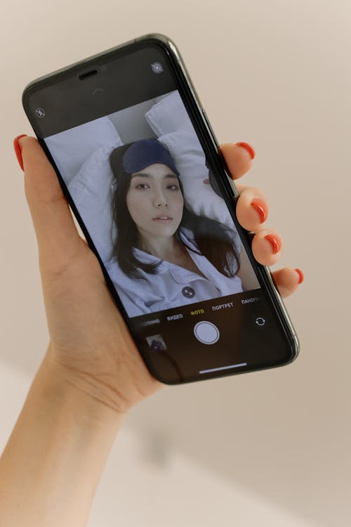 Free Close-up of a Smartphone Screen Displaying a Woman Taking a Selfie  Stock Photo