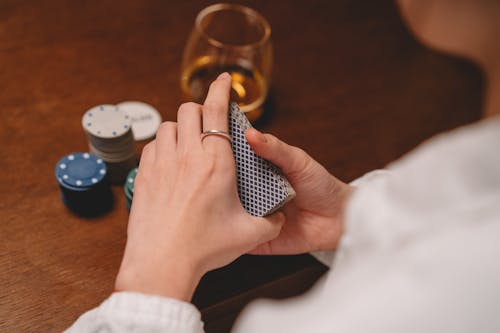 Free Person Holding a Deck of Cards Stock Photo
