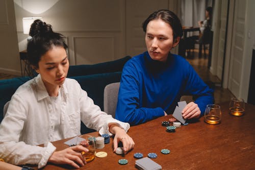 Man Looking at a Woman While Playing Poker