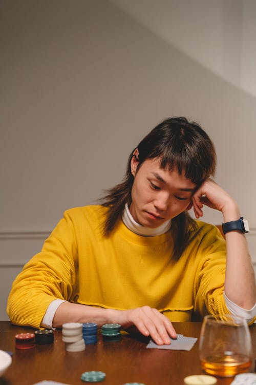 Man with a Mullet Playing Poker by the Table