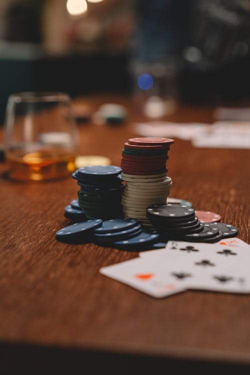 Playing Cards and Casino Tokens on a Wooden Table