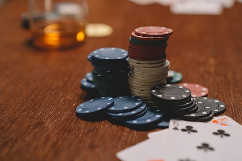 Free Close-Up Shot of Poker Chips on Wooden Surface Stock Photo