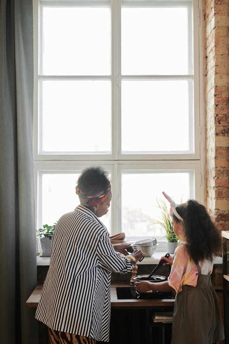 Mom Teaching Her Daughter To Cook