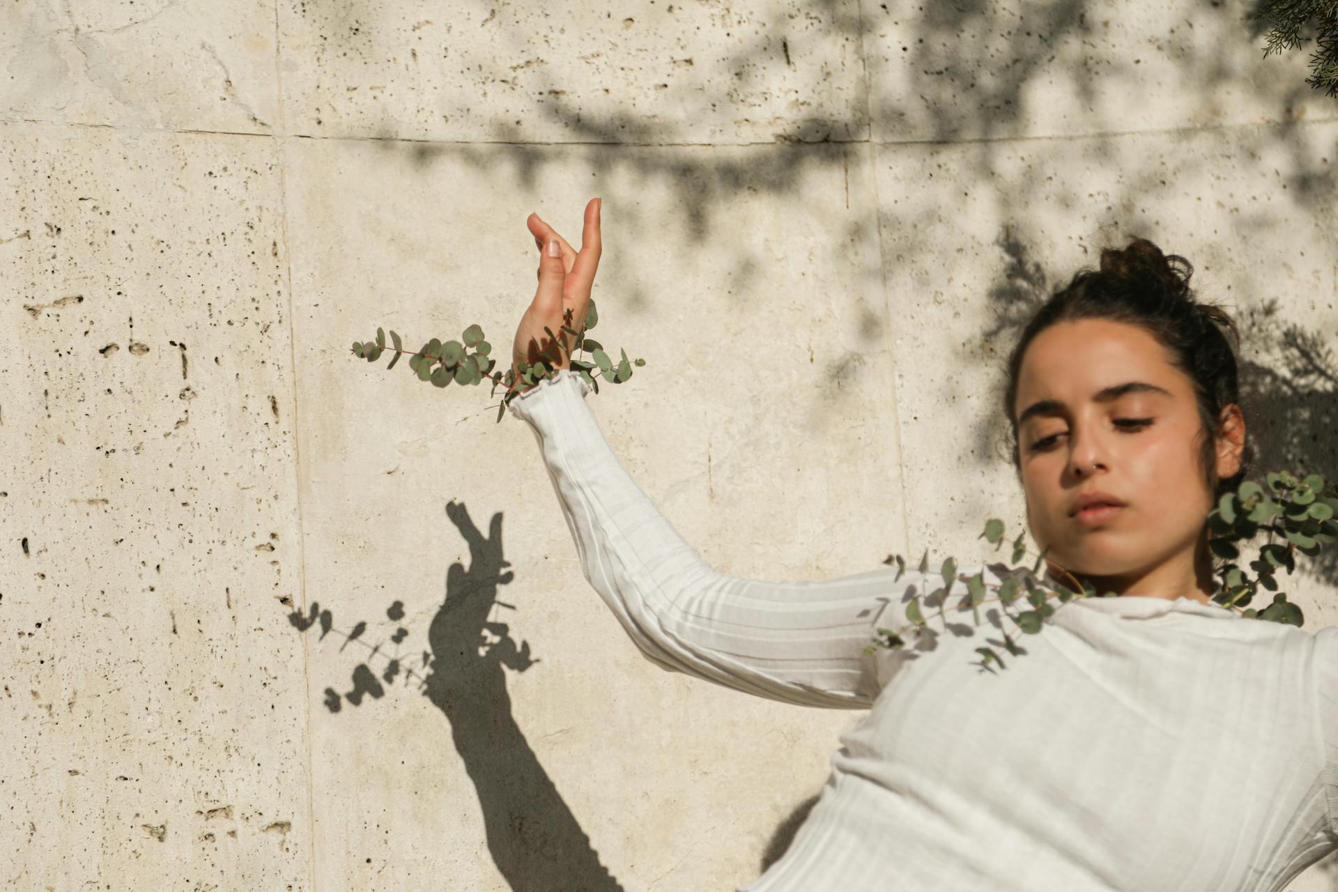 A Girl in White Long Sleeve Shirt with Leaves on Wrist