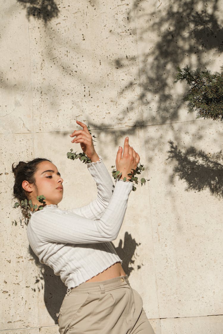 A Girl In White Long Sleeve Shirt Leaning Backwards
