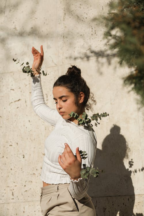 Woman Posing Beside a Wall