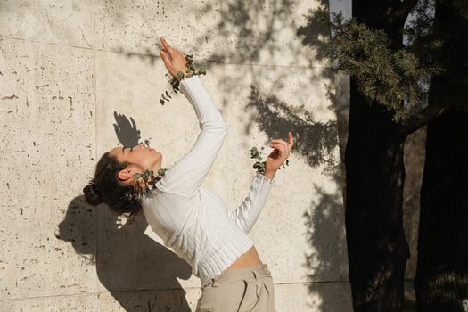 A Girl in White Long Sleeve Shirt Bending Backwards