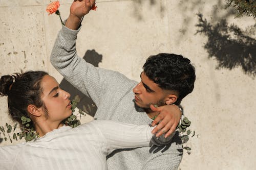 Man and Woman with Leaves Looking at Each Other