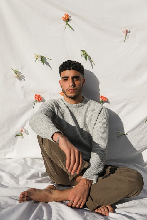 Good Looking Man Leaning on Flowers