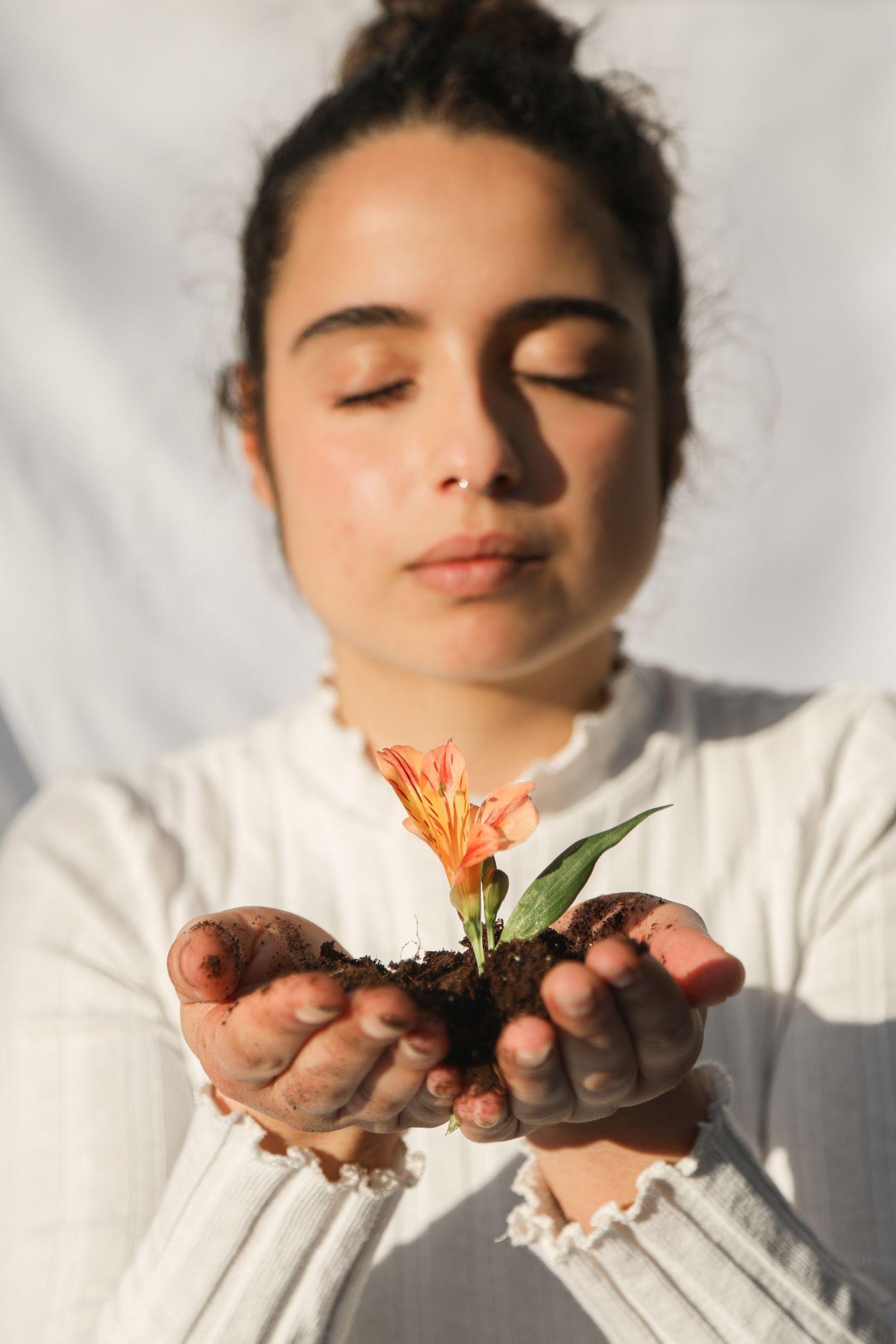 Woman holding a small flower