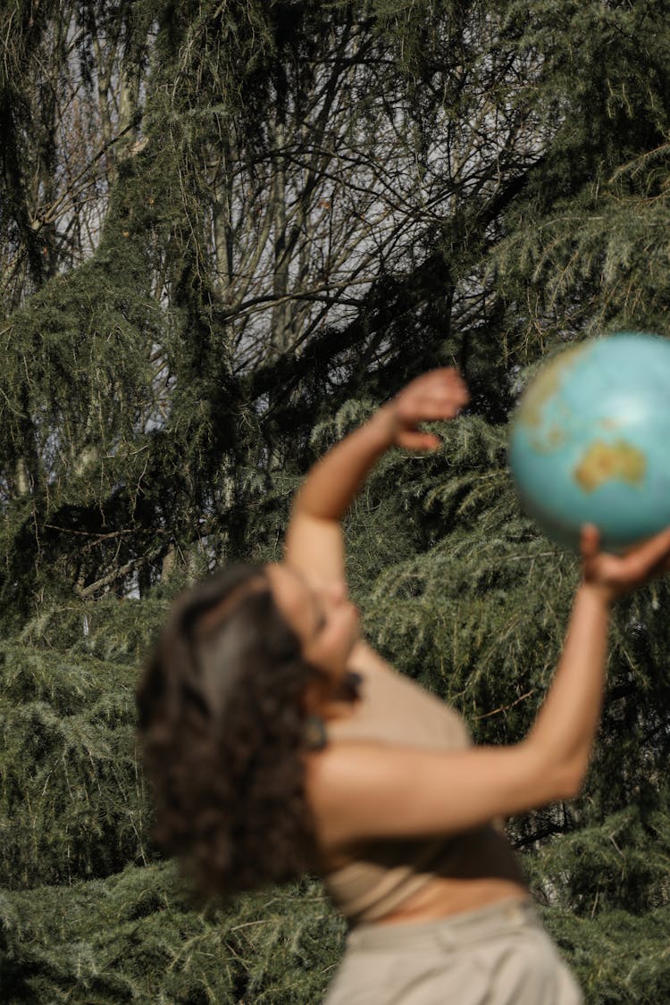 A Blurry Shot Of A Woman Holding A Globe