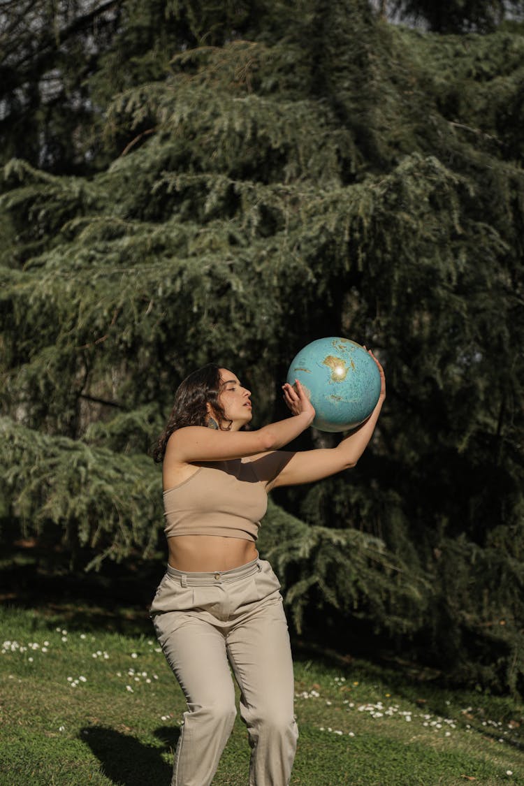 Girl Dancing With Globe In Her Hands