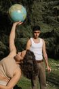 Man in White Tank Top Kissing Woman in Brown Tank Top