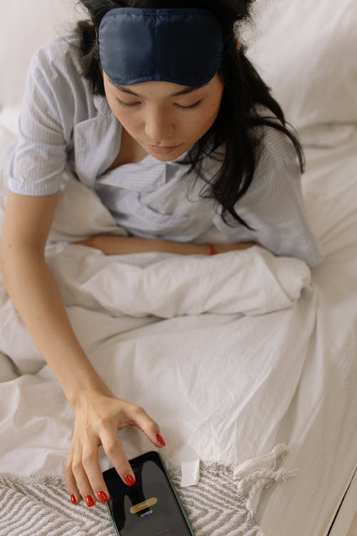 Free A Woman With Red Nails Lying on Bed Stock Photo