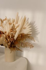 Dried palm fronds in a vase, photo by cottonbro studio on Pexels