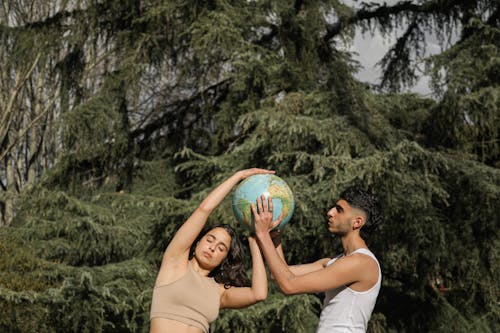 A Man and a Woman Holding a Globe