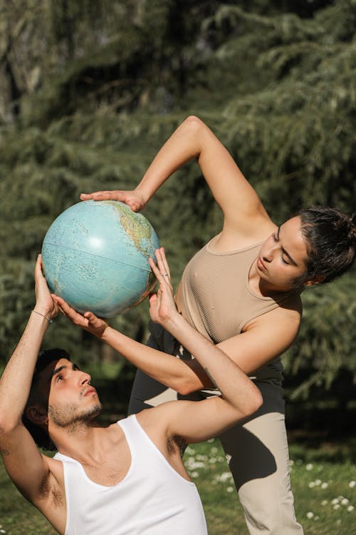 A Couple Holding a Spherical Globe