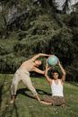 A Man and a Woman Holding a Globe Outdoors