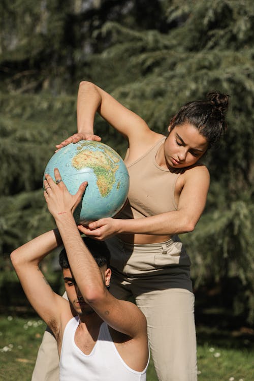 A Couple Holding a Globe in a Photoshoot