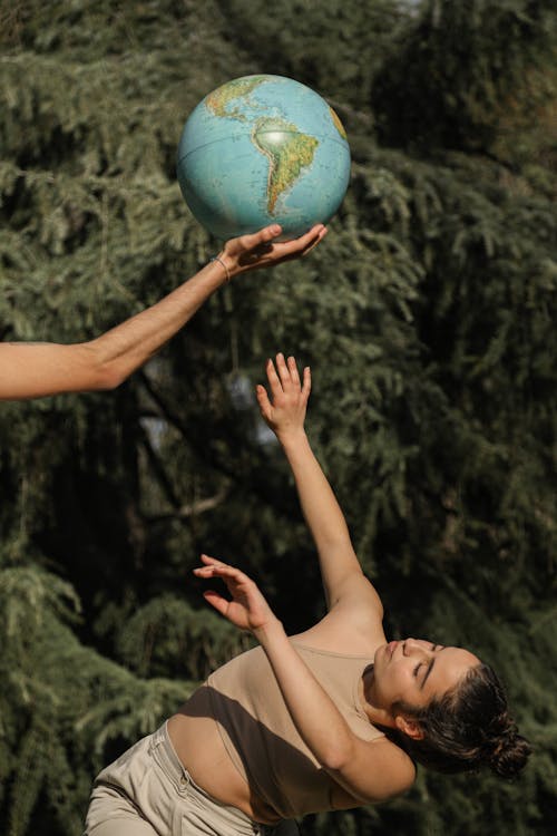 Free People Posing with a Globe Stock Photo