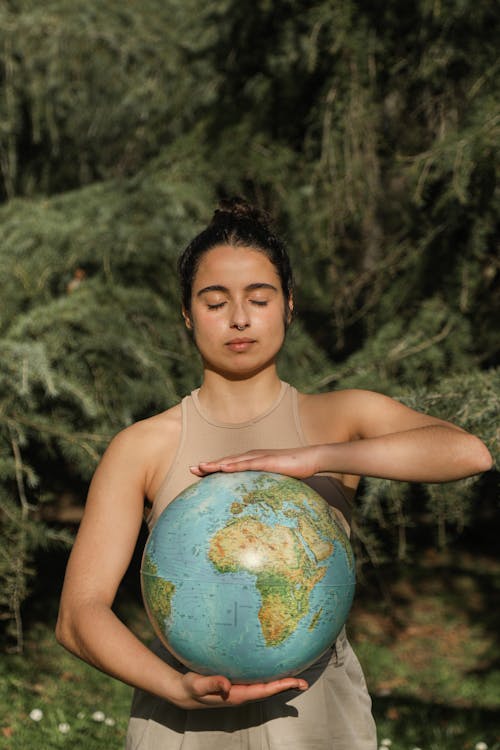 Woman Posing Holding a Globe