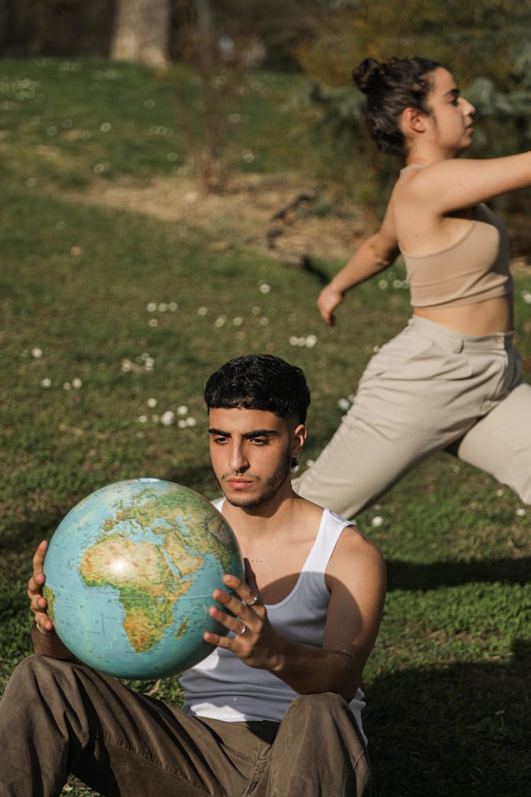 Man Holding A Globe