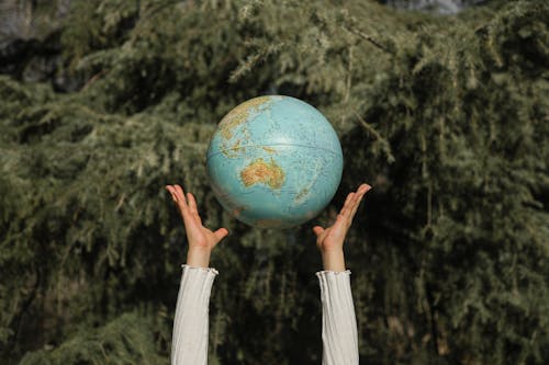 Person Tossing a Globe