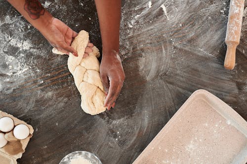 Free Person Holding White Dough on Stainless Steel Surface Stock Photo