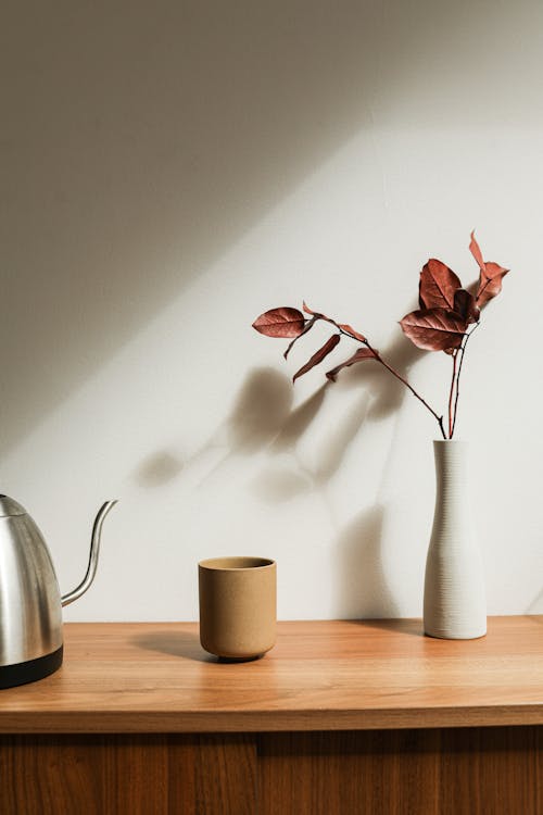 Free Brown Ceramic Cup Beside White Ceramic Vase Stock Photo
