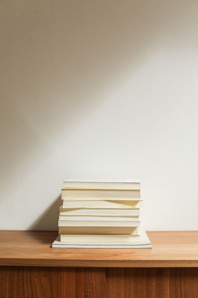 Minimalist stack of books on a wooden desk