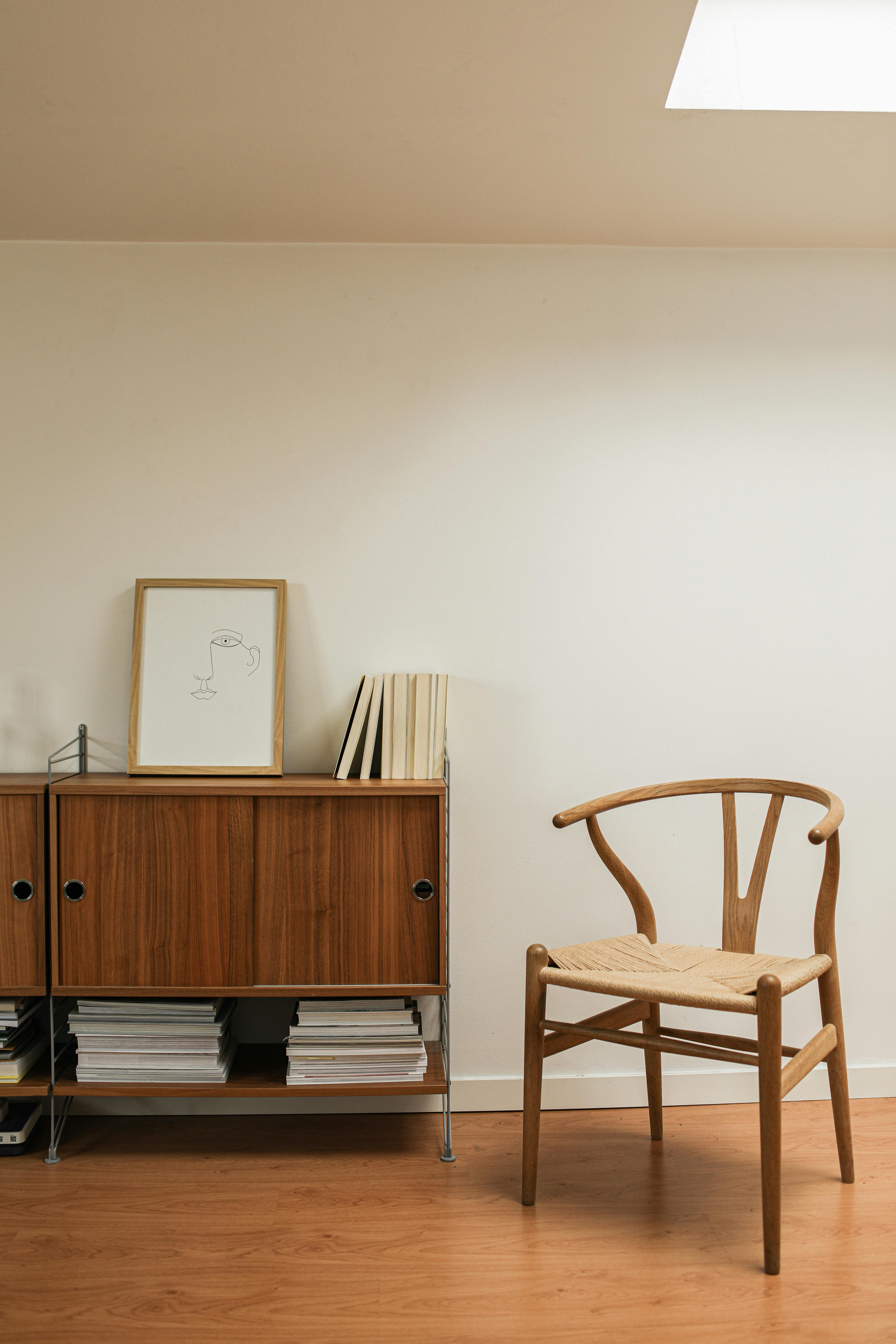 wooden chair beside a cabinet