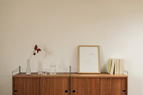 Picture Frame and Book Beside Glass Items