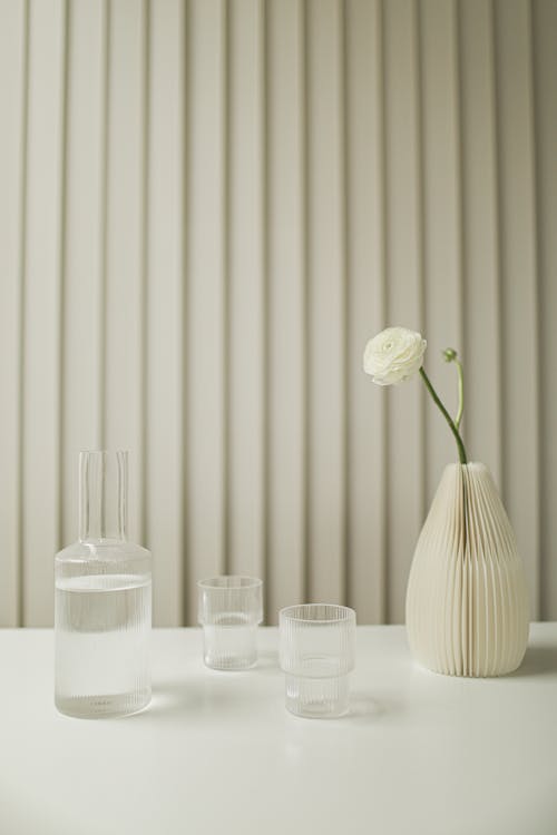 Free Water Glasses Beside White Flower Vase with White Flower Stock Photo