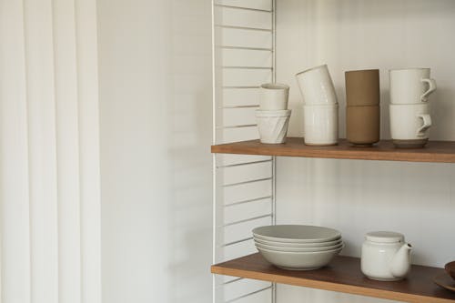 Free Shelves with Ceramic Cups and Plates Stock Photo