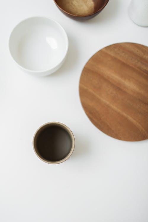 Free Ceramic Cup, Bowl and Wooden Board on White Table Stock Photo