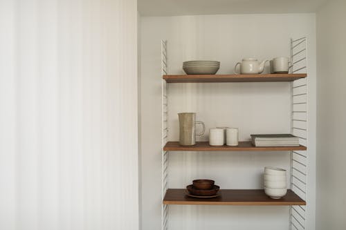 Ceramic Tableware on a Shelf in a Minimalist Interior 