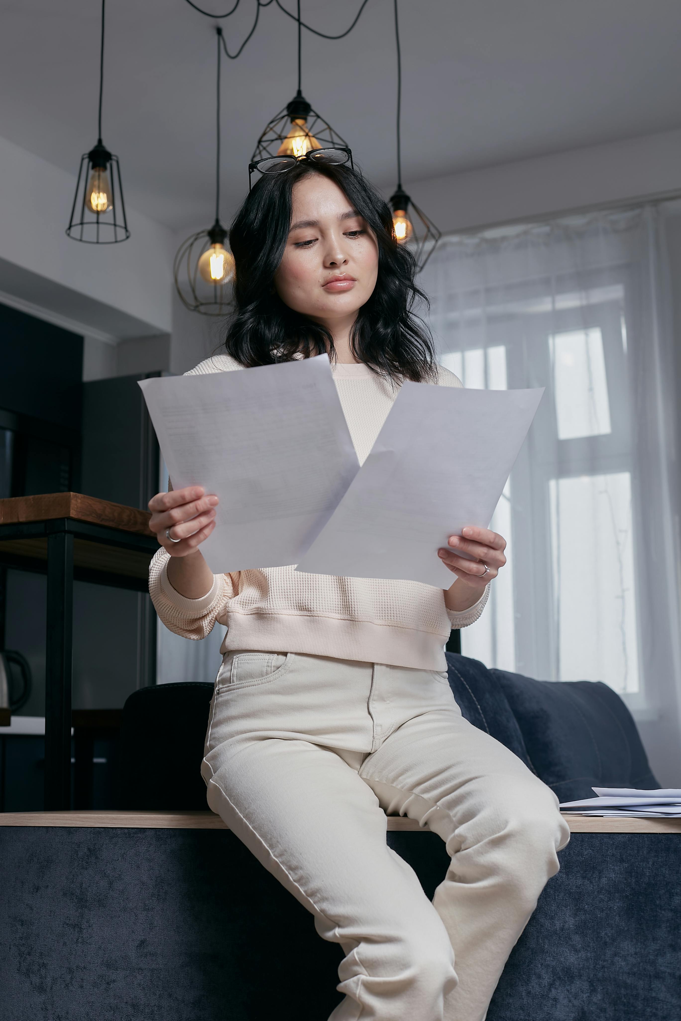 a woman holding white printer paper