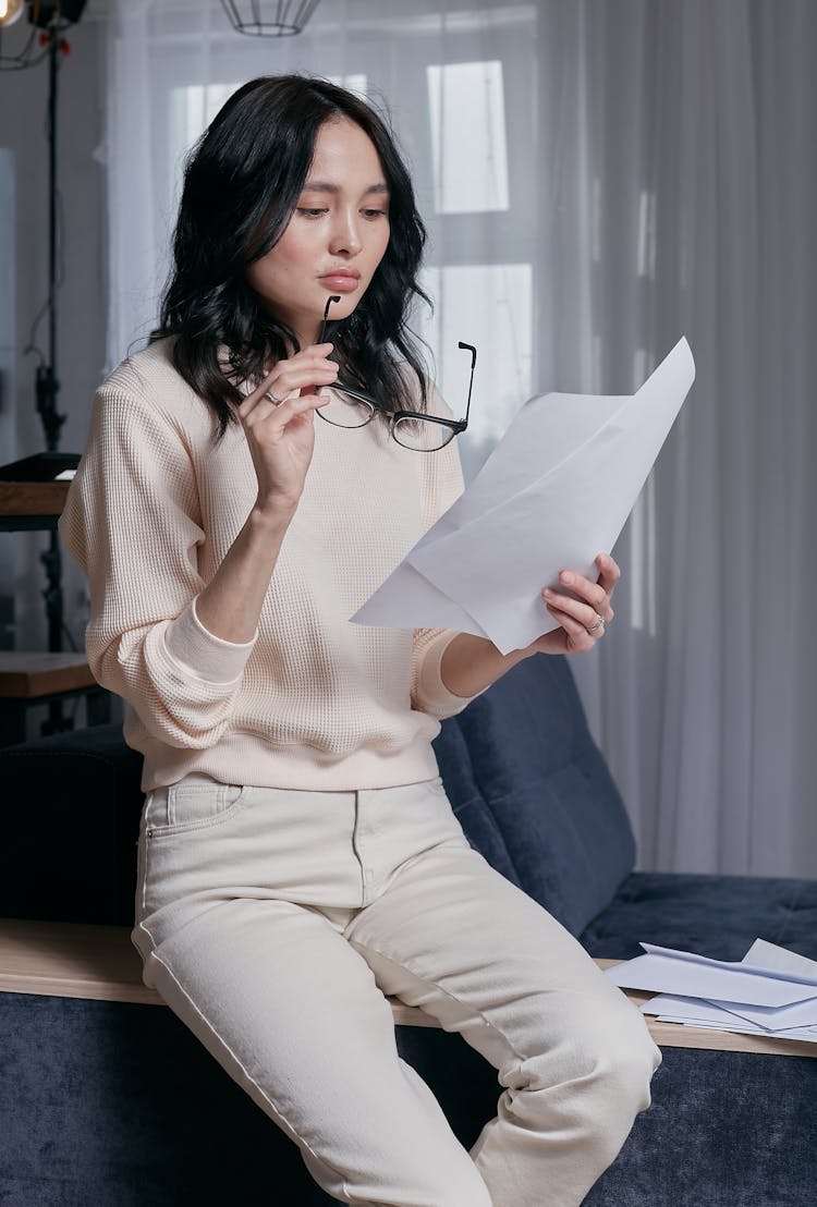 A Woman Reading From A Paper