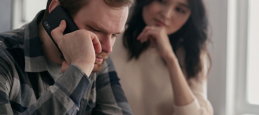 Stop an IRS Levy — Bank Levy & Asset Seizure Help Worried couple reviewing an IRS levy notice and overdue bills at the kitchen table — bank levy and asset seizure help in Orlando, FL
