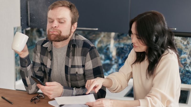 homeowner reviewing an electric bill at a kitchen table