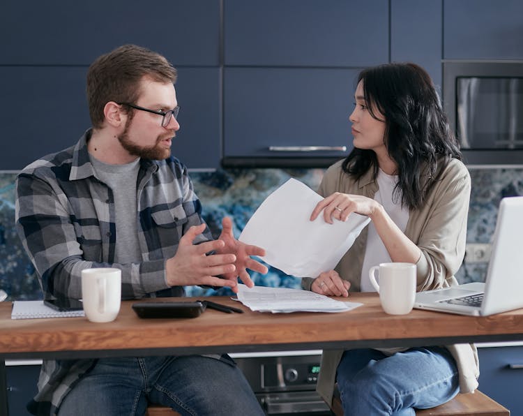 Man And Woman Sitting At Table Having A Conversation