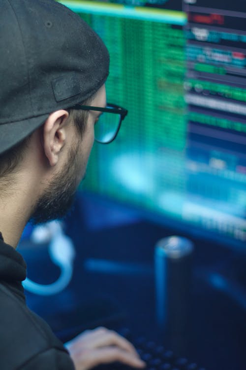  A Man Wearing Cap Using a Computer